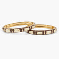 Brown and cream designer bangle set with geometric enamel pattern, angled view