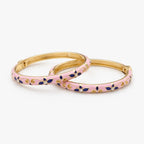 Pink floral enamel bangle bracelet set with crystal accents, angled view