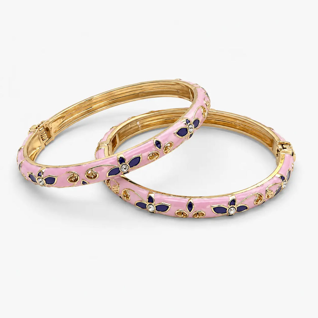 Gold-tone pink enamel bangle pair with navy floral detailing, front view
