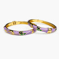 Purple Enamel Bangles Pair With Green Bow Motifs And Gold-Tone Hinged Design On A White Background