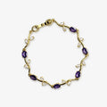 Bracelets for women with purple oval stones and clear leaf-shaped stones arranged around a gold-colour vine bracelet, full view.
