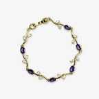 Bracelets for women with purple oval stones and clear leaf-shaped stones arranged around a gold-colour vine bracelet, full view.