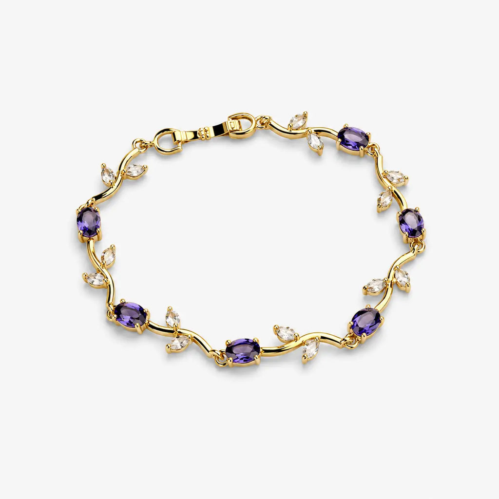 Bracelets for women with purple oval stones and clear leaf-shaped stones on a polished gold-colour vine design, angled view.