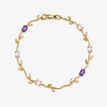 Hand bracelet with purple, pink and clear oval stones plus pale leaf-shaped accents on a polished gold-colour vine design.