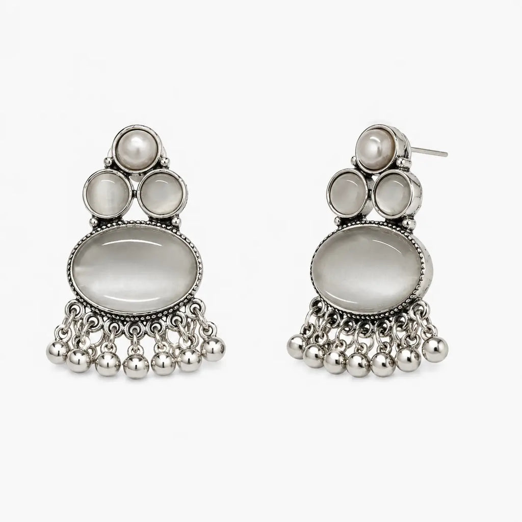 Artificial silver earrings with grey oval stone-look centres, pearl-look tops and dangling bead fringe, angled view