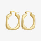 Hoop earrings in a smooth gold-tone rounded square shape with chunky polished profile, angled view