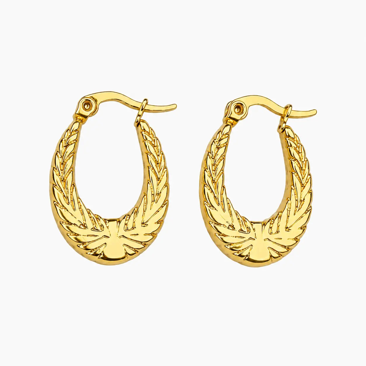 Hoop earrings in gold tone with broad oval shape and engraved leaf-inspired texture, angled view