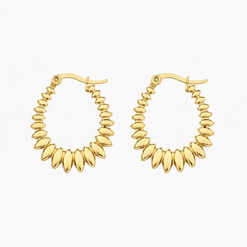 Hoop earrings in gold tone with graduated polished oval bead-like elements, angled view