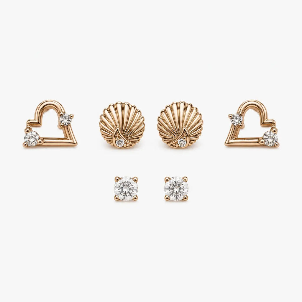  Stud earrings set with rose-gold-colour heart, shell and round clear stone designs arranged in a front view.