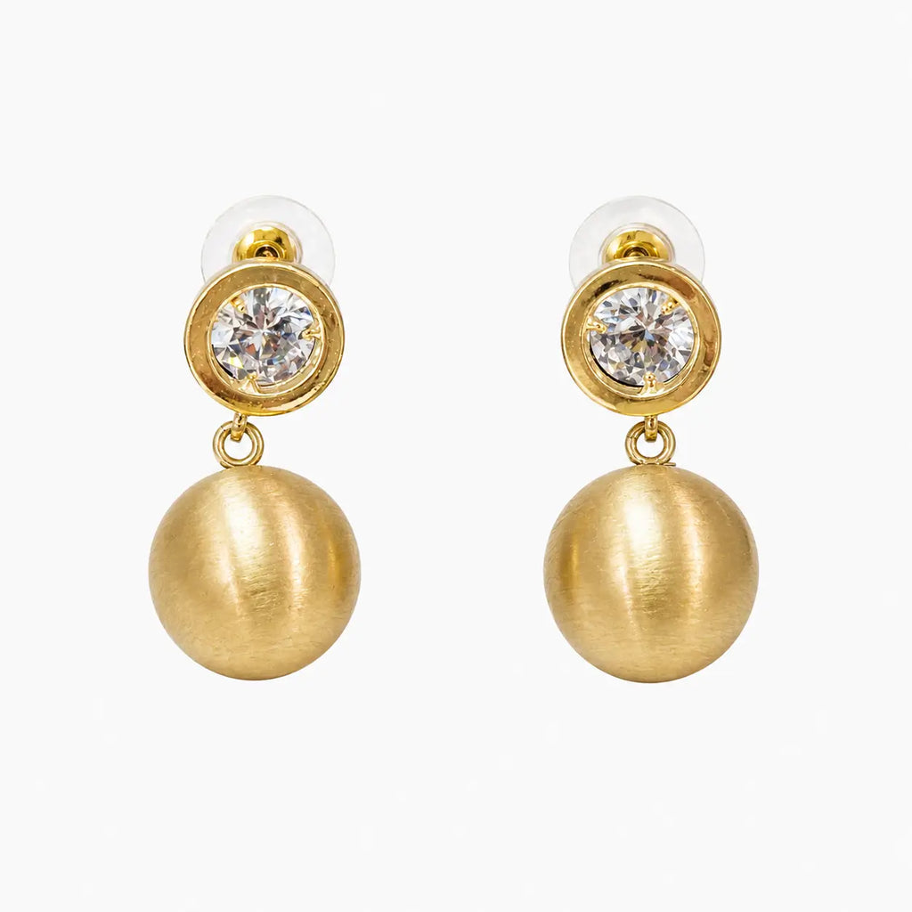 Crystal stud and brushed gold ball drop earrings on white background, front view