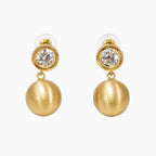 Crystal stud and brushed gold ball drop earrings on white background, front view