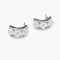 Silver-tone white flower huggie hoop earrings – front view
