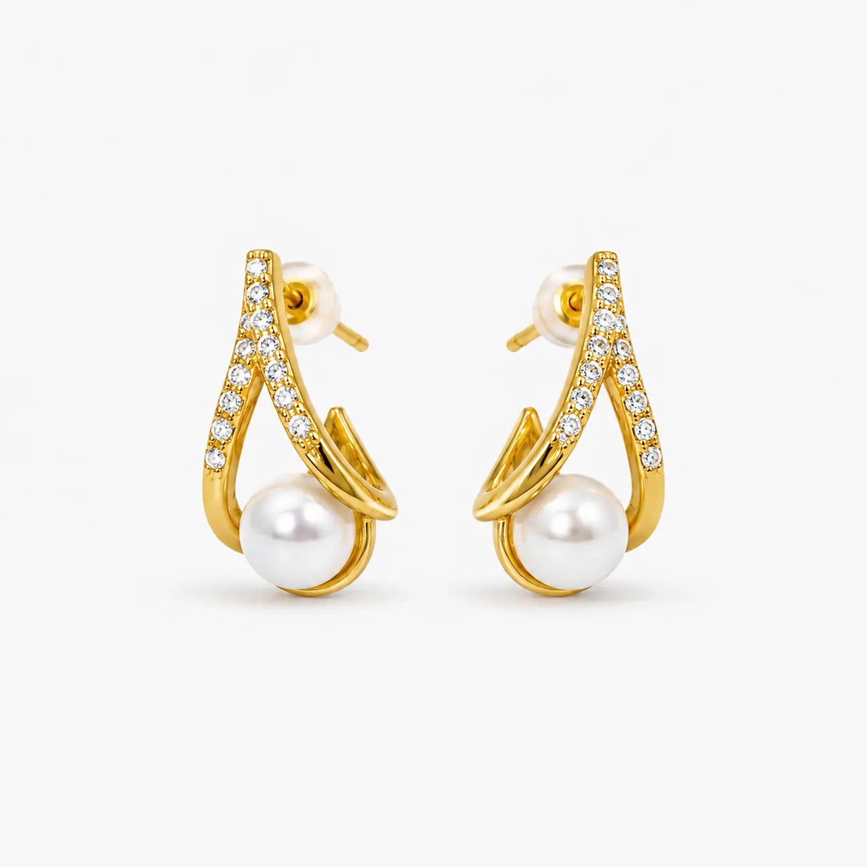 Gold-tone curved pearl-style stud earrings with clear stone details – front view