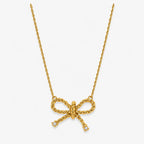 clear-accent bow pendant necklace on twisted gold-colour chain