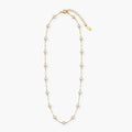 white bead station necklace on long gold-color chain