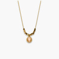 Peach oval pendant necklace with bead-and-bar chain accents