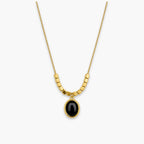 Black oval pendant necklace with bead-and-bar chain accents