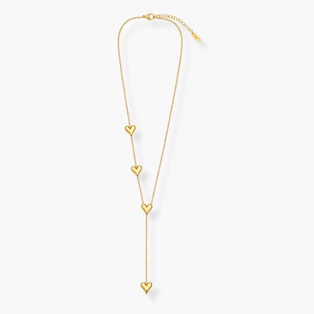 Close-up of gold-tone heart charm on Y-shaped necklace