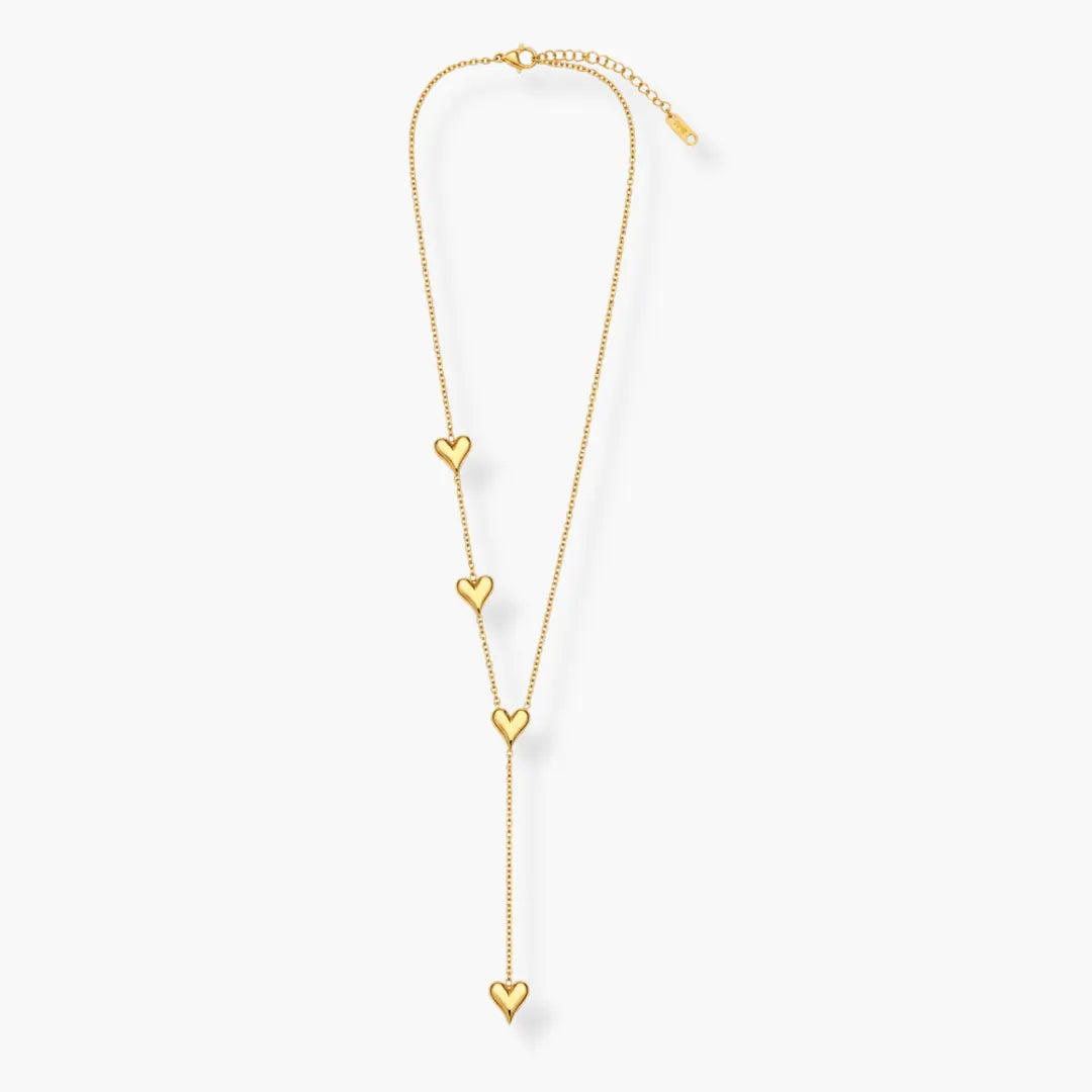 Close-up of gold-tone heart charm on Y-shaped necklace