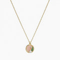Close-up of a gold-tone pendant necklace with pink swirl centre, green leaf, clear stone and pearl-like accent.