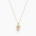 Close-up of a gold-tone pendant necklace with pearlescent flower petals, pearl-like centre and delicate stem.