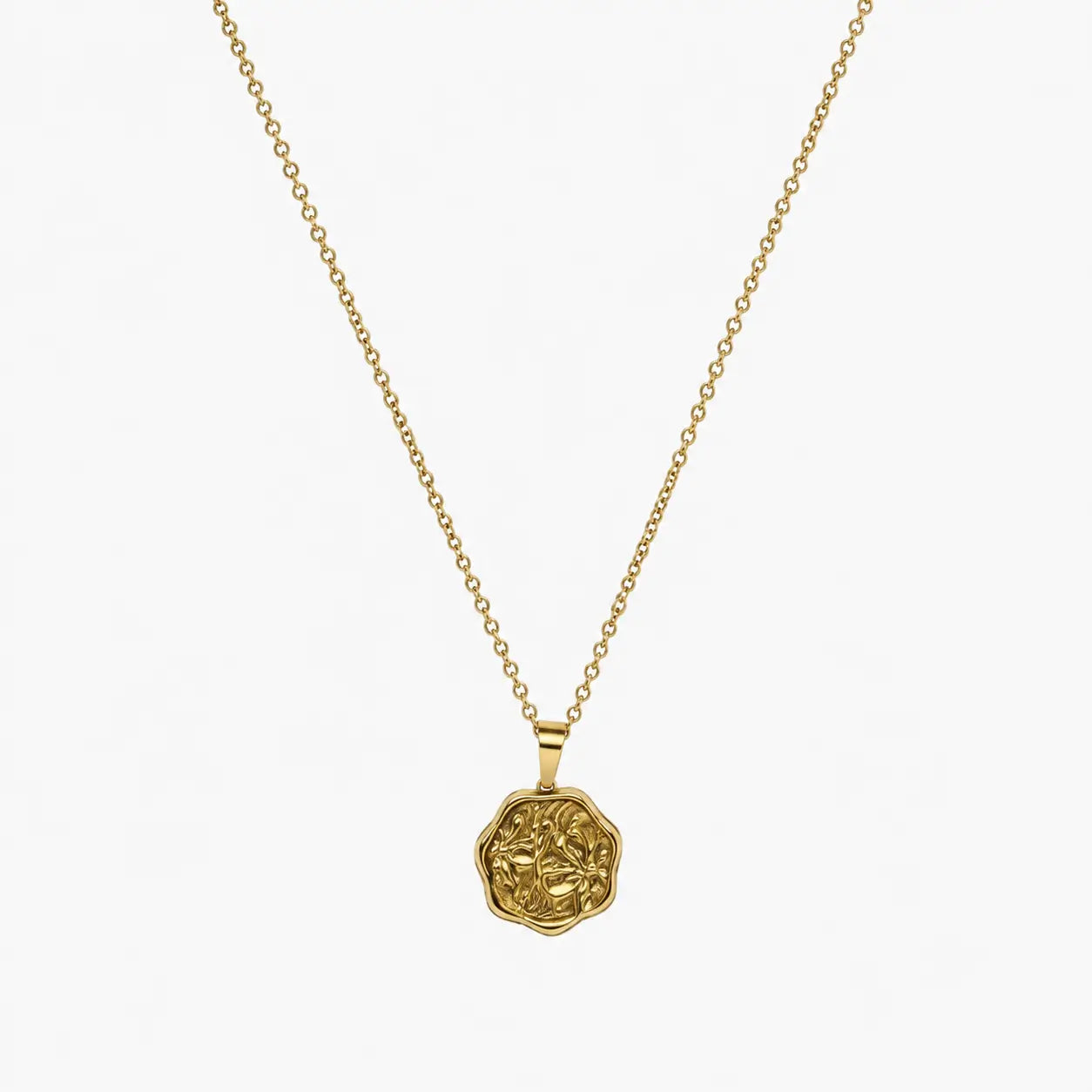 Close-up of a gold-tone artificial pendant necklace with an irregular embossed floral coin charm.