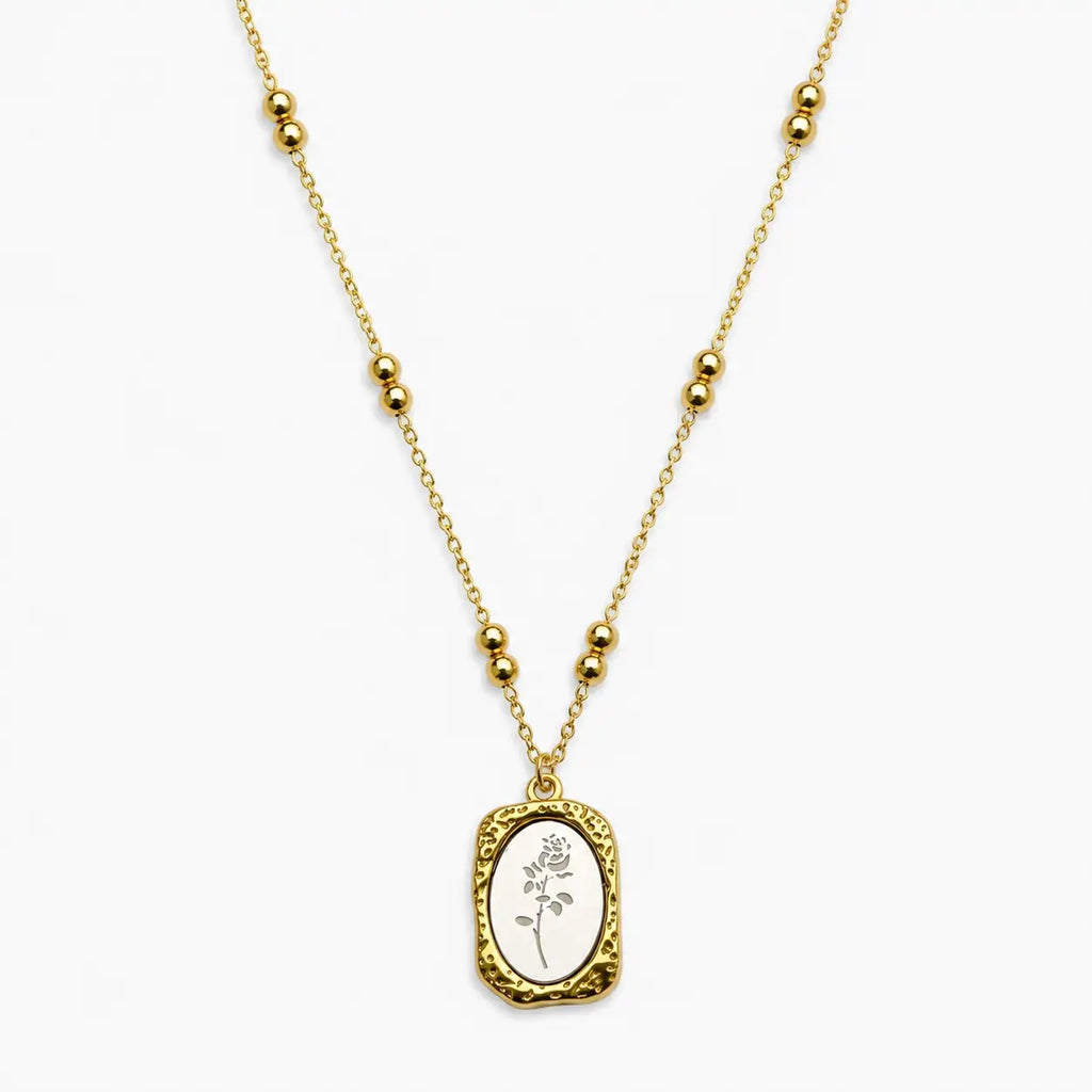 Close-up of a Two-tone chain necklace with paired beads and a textured rectangular rose pendant.