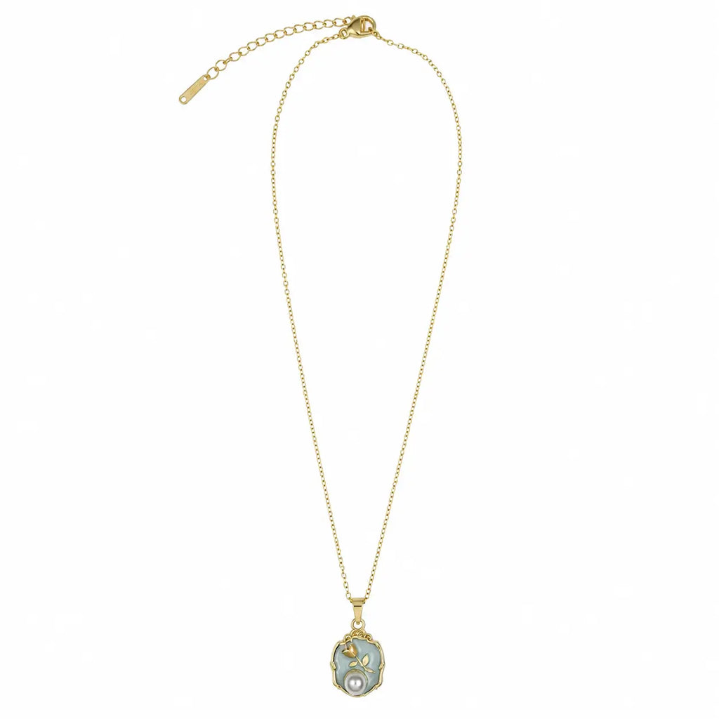 Full view of the gold-tone necklace for women with a green floral pendant, fine link chain, clasp and extender.