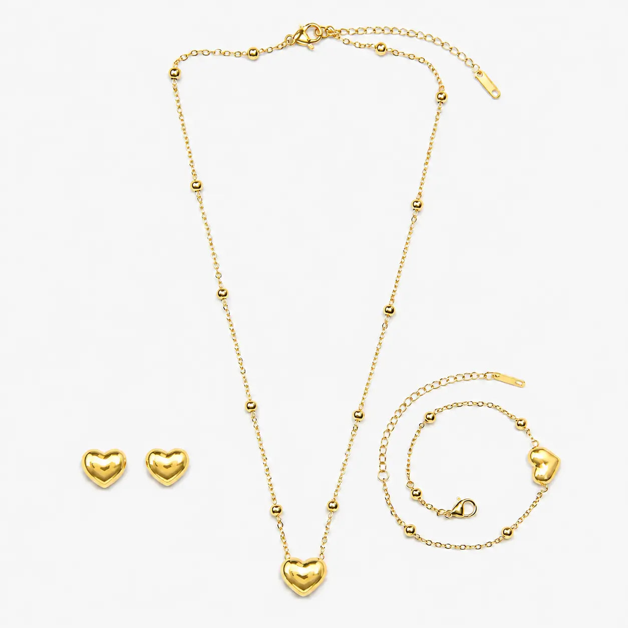Gold-tone artificial necklace set with heart pendant, beaded bracelet and matching heart stud earrings.