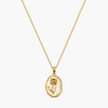 Pendant necklace with gold-tone oval frame, raised rose motif and pearlescent-look white centre, close-up view