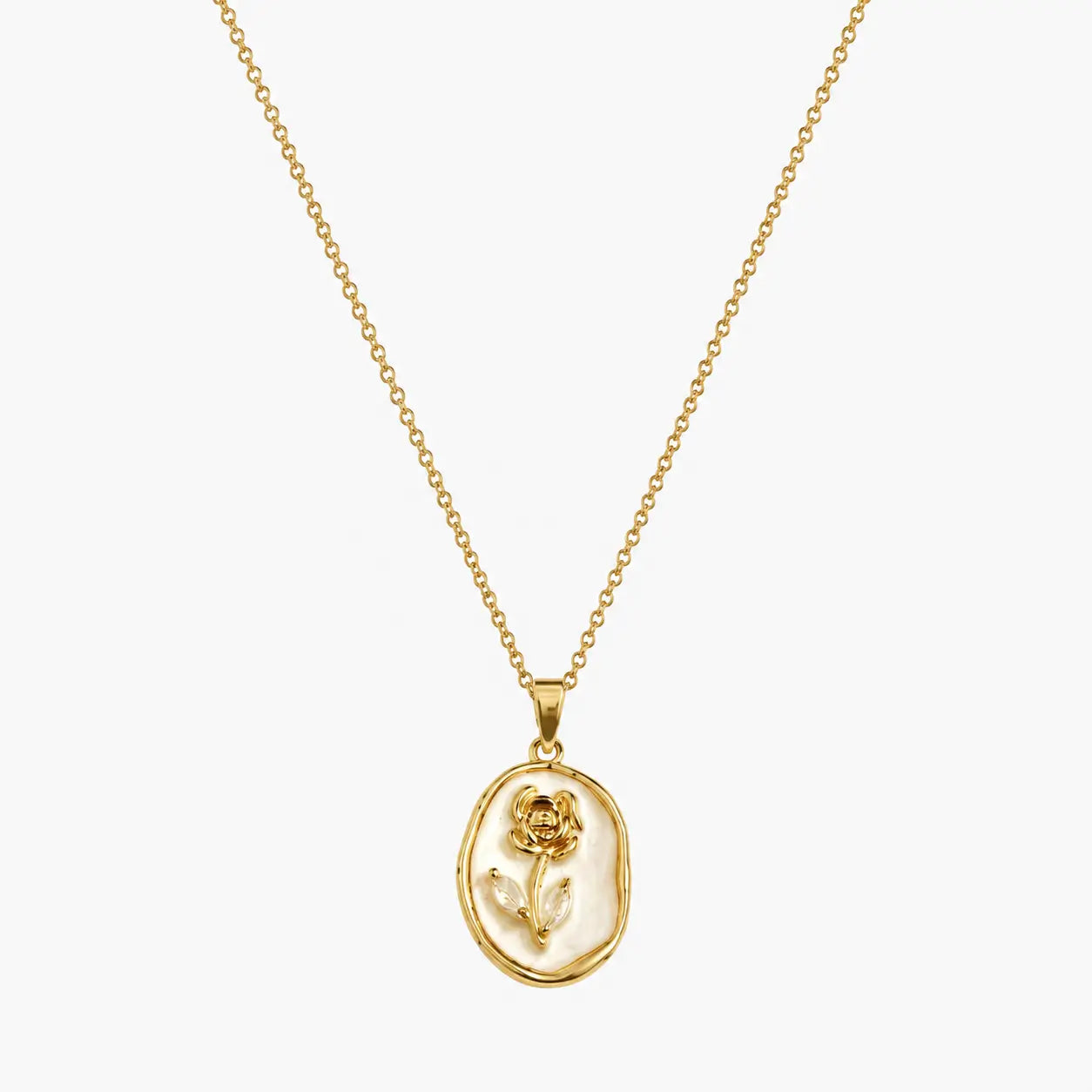 Pendant necklace with gold-tone oval frame, raised rose motif and pearlescent-look white centre, close-up view