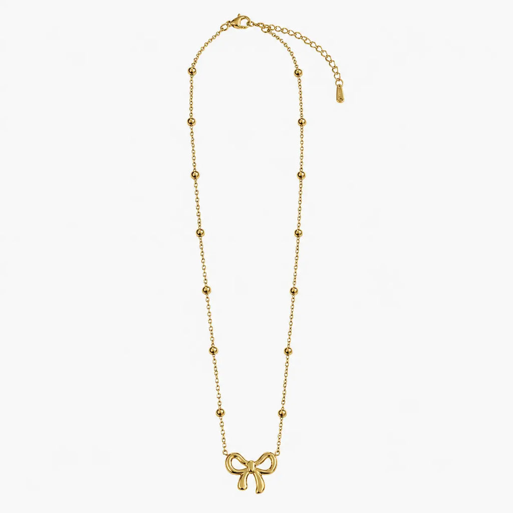 Necklace for girls in gold tone with bow charm, bead-accent chain, lobster clasp and extender, full product view
