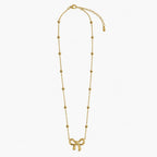 Necklace for girls in gold tone with bow charm, bead-accent chain, lobster clasp and extender, full product view