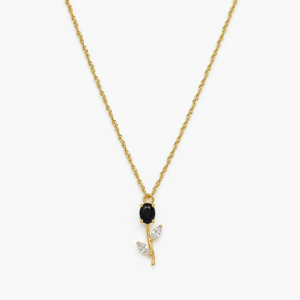 Close-up of black crystal tulip pendant with marquise leaf details on gold-tone chain