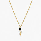 Close-up of black crystal tulip pendant with marquise leaf details on gold-tone chain
